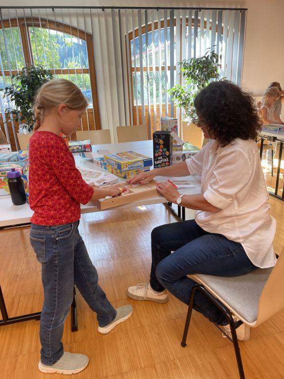 Erwachsene und ein Mädchen beim Spielen